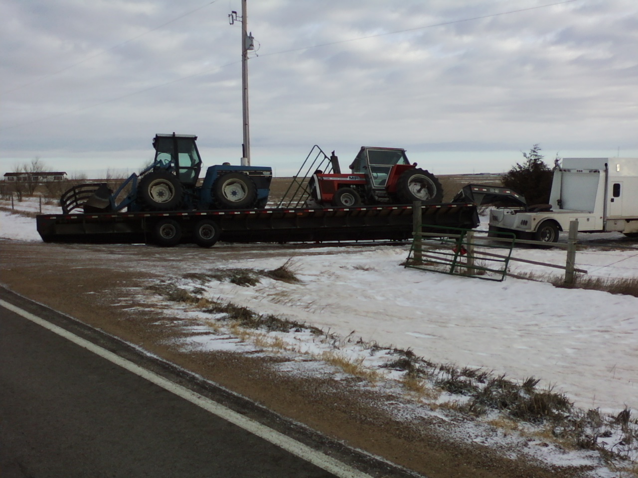 Too small of an approach left this trailer trying to dump it's load. After setting the trailer back on the road we had to pull one of the tractors back onto the trailer. All was completed without incident. 




