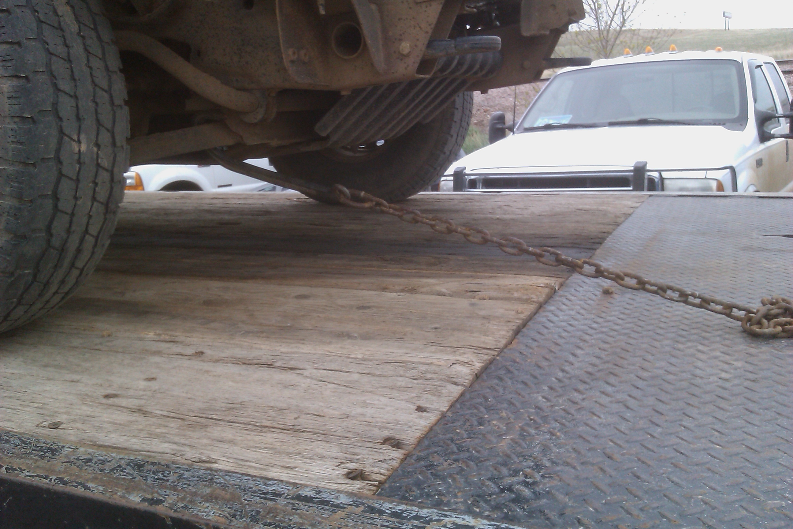 proper safety hook up of front of pickup on rear of flatbed.